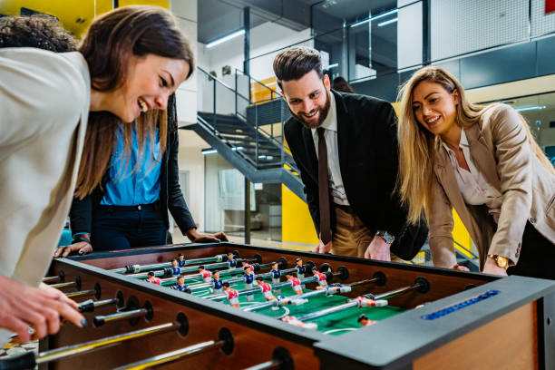 istock Businesspeople playing foosball in office 1286208042