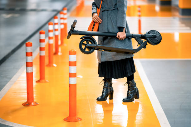 istock Woman holding her folded electric scooter while heading to work 1286210350