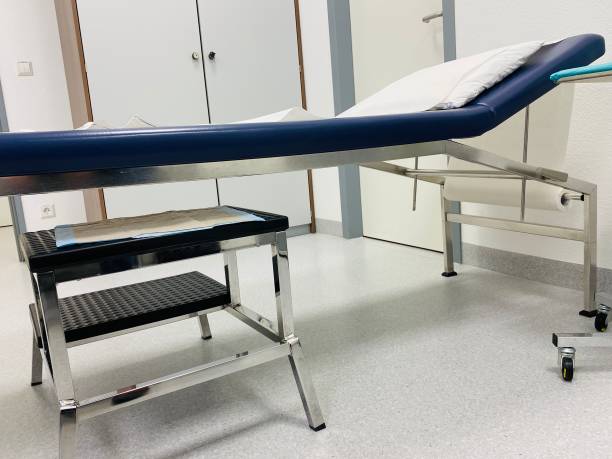 istock Doctor examination bed and step chair 1286211441