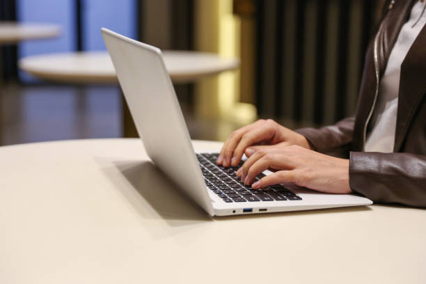istock woman's hands are typing on laptop 1286214706