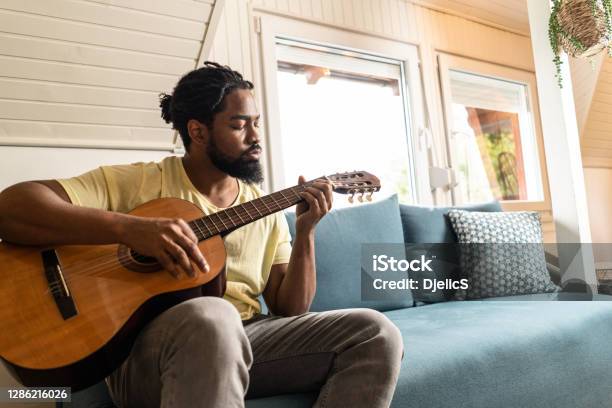 Man Playing A Guitar At Home Stock Photo - Download Image Now - Guitar, African-American Ethnicity, Playing