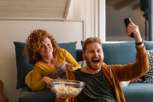 istock Ecstatic young couple watching tv. 1286216118