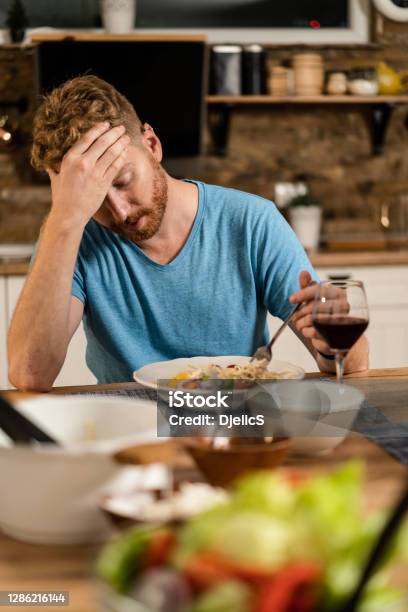 Depressed Young Man Having No Appetite To Eat Stock Photo - Download Image Now - Eating, Men, Stomachache