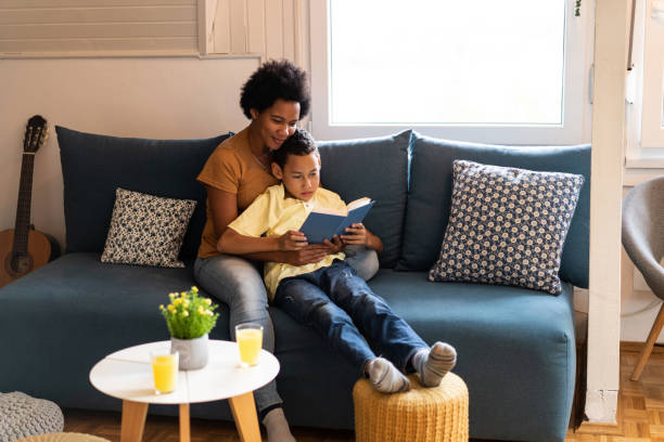 istock Mother and son reading a book together. 1286216343