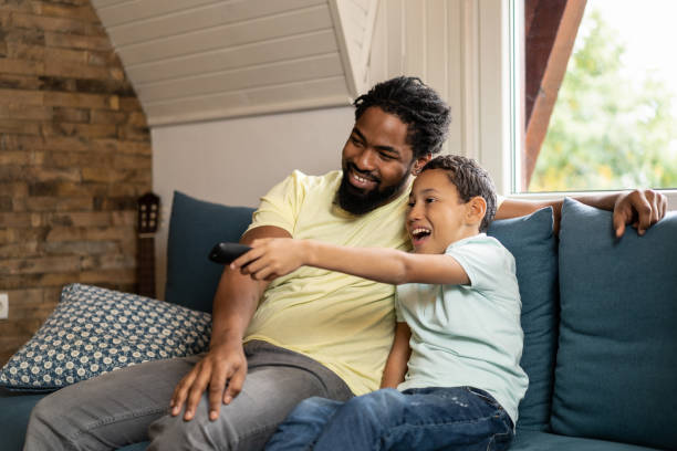 istock Father and son watching tv together. 1286216393