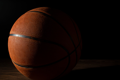 Pelota de baloncesto en un fondo oscuro. photo