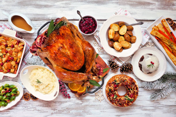 istock Traditional Christmas turkey dinner. Above view table scene on a rustic white wood background. 1286217430