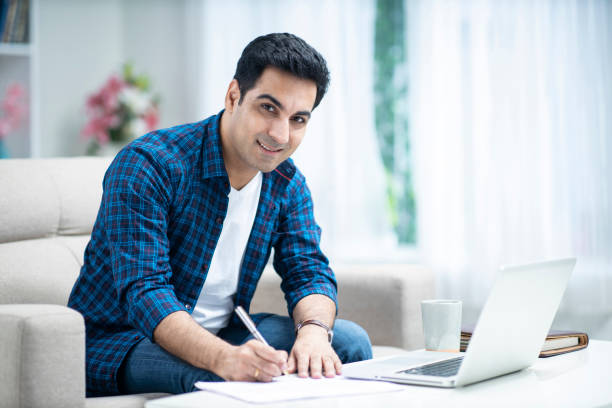 istock Young man at home sofa sitting - stock photo 1286220124
