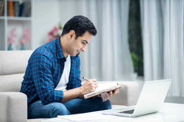 istock Young man at home sofa sitting - stock photo 1286222284