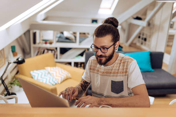 istock Young man studying online at his home office 1286224319