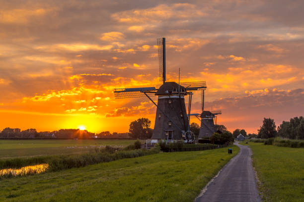 istock Historic wooden windmills orange sunset 1286224947