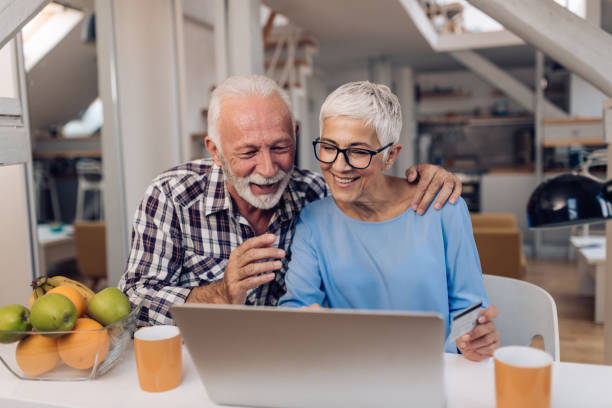istock Happy senior couple enjoying while shopping online 1286225133