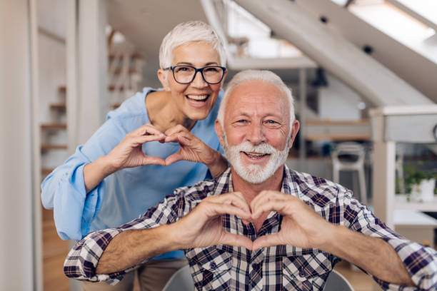 istock Happy senior entrepreneurs  showing hearts 1286225178