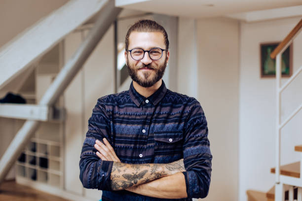 portrait of a handsome young man posing at home - portrait tattoo photography color image imagens e fotografias de stock