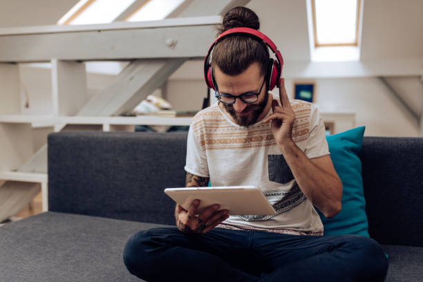istock Young man enjoying music at home 1286225223
