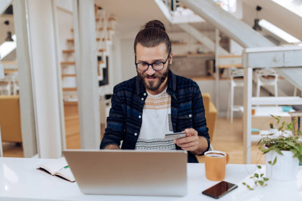 istock Young man checking his bank account at home 1286225277