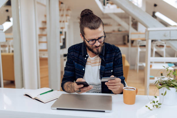 istock Young man spending money online 1286225289