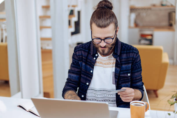 istock Young man making an online payment at his home office 1286225301