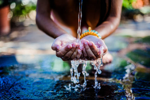 istock Child drinking water with his hands 1286226368