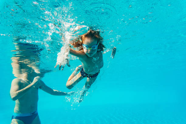 istock Little boy with father underwater 1286232711