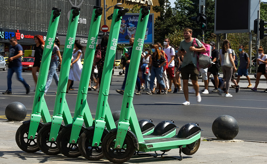 Bucharest, Romania - July 23, 2020: Bolt electric scooters are parked on a sidewalk in Bucharest. This image is for editorial use only.