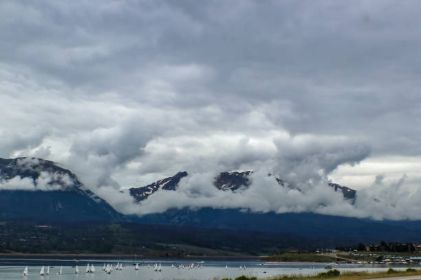 lago dillon in colorado usa con nuvole coperte montagne rocciose in lontananza e barche a vela in acqua - lake dillon foto e immagini stock