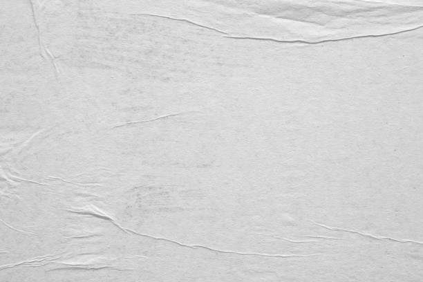 istock Blank white crumpled and creased paper poster texture background 1286235544