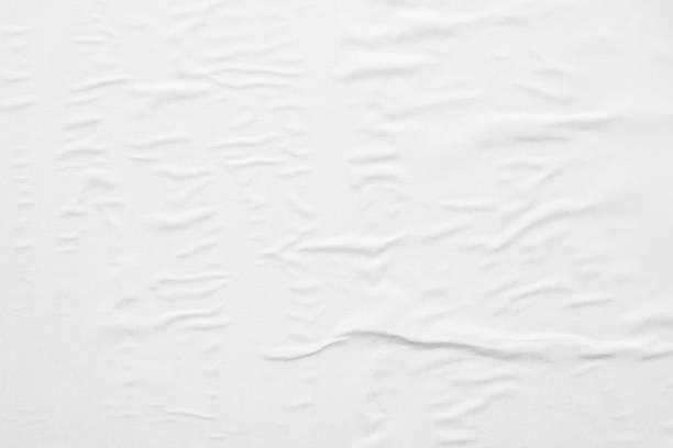 istock Blank white crumpled and creased paper poster texture background 1286235612