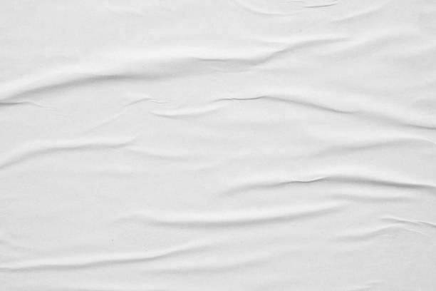 istock Blank white crumpled and creased paper poster texture background 1286235620