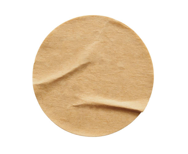 istock Brown round paper sticker label isolated on white background 1286235703