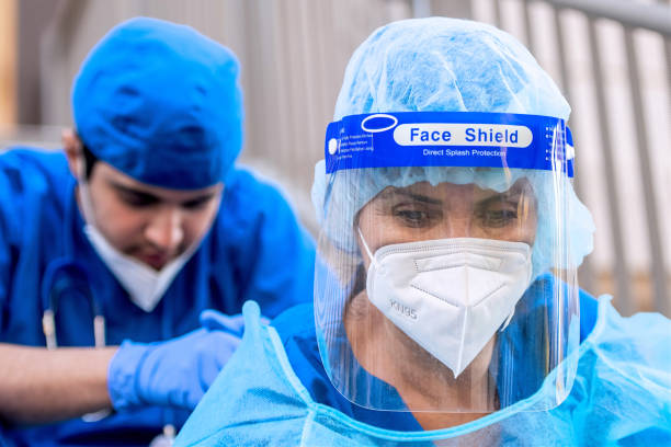 istock Serious, pensive, overworked, health care workers sitting looking down very sad 1286236800