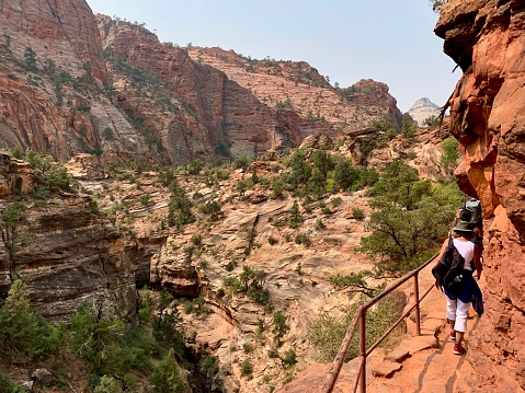 Zion NP, Utah, USA - September 7,2020: Tourists are hiking Canyon Overlook Trail over the Pine Creek Gorge in Zion National Park in Utah, USA.