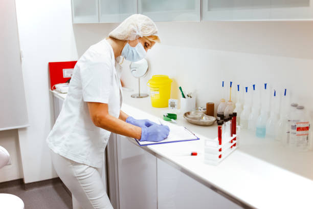 istock Female doctor  analyzing blood samples in laboratory 1286241107