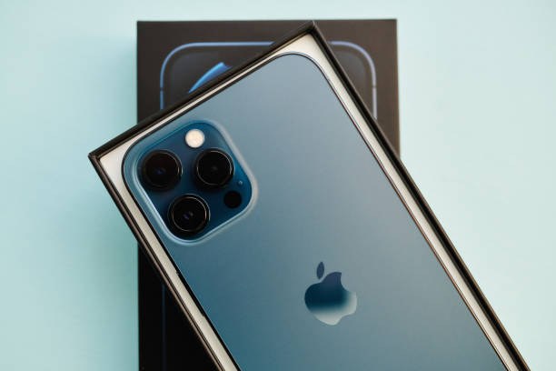 brand new iphone 12 pro max in pacific blue in studio setting - iphone imagens e fotografias de stock