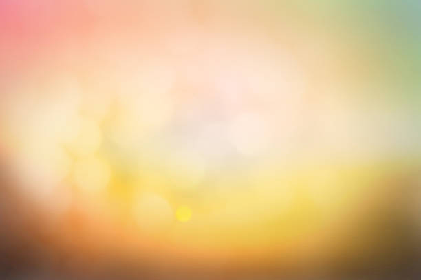 istock Hope concept; Abstract blurred sunrise background blurring warm colors calm bright sunlight. Sky effect gradient white sun at color orange light yellow soft flare patterns blur plain morning summer. 1286255486