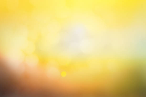 istock Hope concept; Abstract blurred sunrise background blurring warm colors calm bright sunlight. Sky effect gradient white sun at color orange light yellow soft flare patterns blur plain morning summer. 1286257267