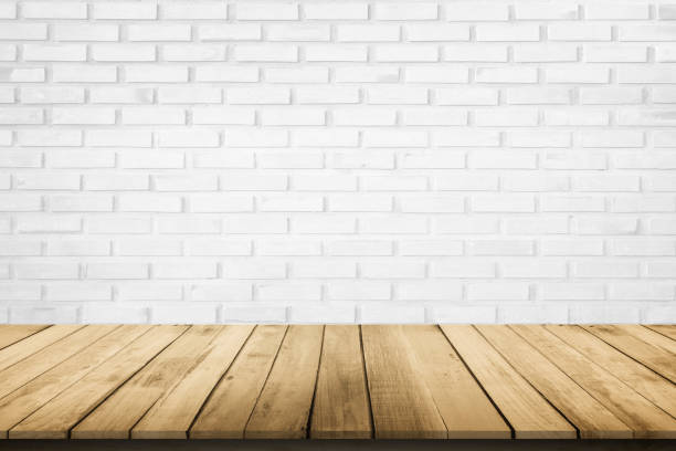 istock Empty wooden table top on white brick wall background, Design wood terrace white. Perspective for show space for your copy and branding. Can be used as product display montage. Vintage style concept. 1286258712
