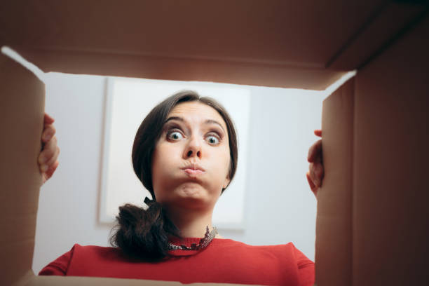 istock Disappointed Woman Looking Inside Cardboard Gift Box 1286258758