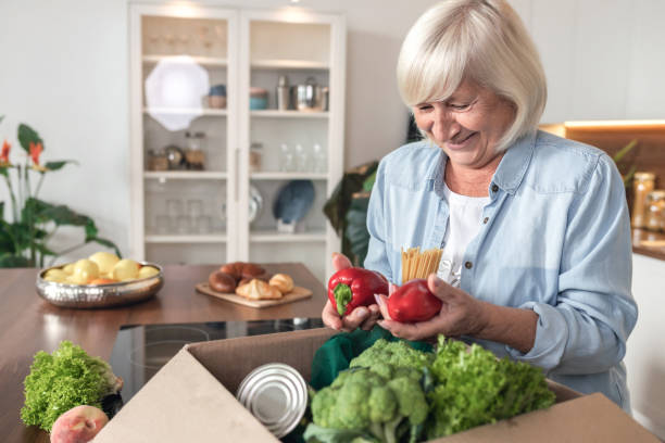 istock Pensioner received help, box with food during quarantine period 1286261522