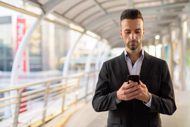 istock Italian businessman outdoors in city using mobile phone 1286264026