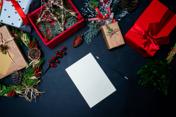 istock Christmas decorations and presents on black background with a blank Christmas card 1286264113