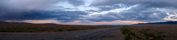 istock Panoramic landscape of Kazakhstan steppe in evening time with rain clouds. Clouds background. Beautiful natural wallpaper. 1286264973