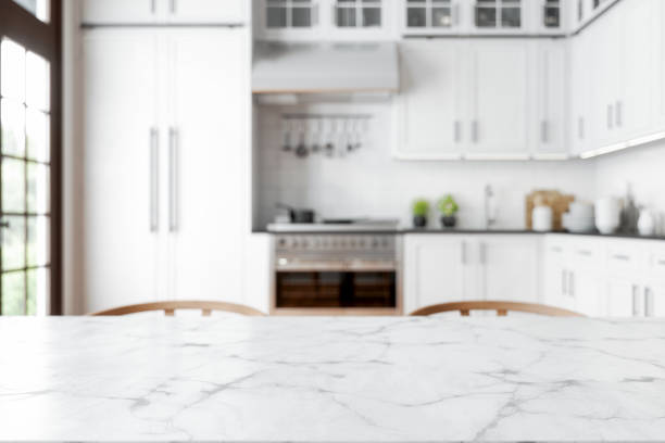 Empty Marble Dining Table With Wooden Chairs And Defocused Kitchen Background. Empty Marble Dining Table With Wooden Chairs And Defocused Kitchen Background. dining table stock pictures, royalty-free photos & images