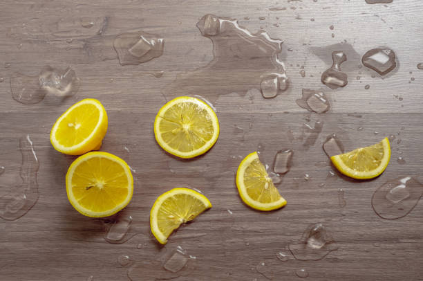 Top view image, Fresh yellow ripe lemon sliced fruits on brown wooden table with Ice