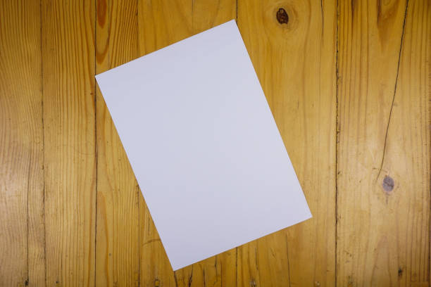 istock blank paper sheets on wooden table. vintage copy space background concept 1286268392
