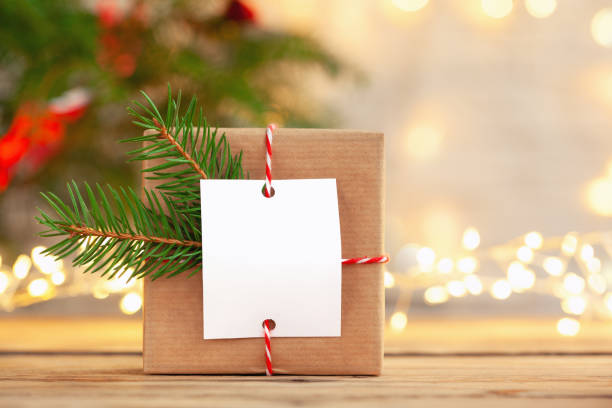Christmas handmade gift box with blank gift card on a wooden table stock photo