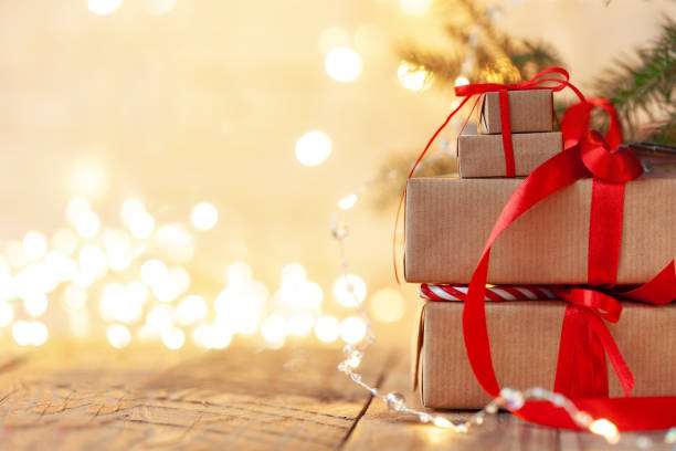 istock Stacks of Christmas presents laid under a Christmas tree with defocused lights. 1286269095