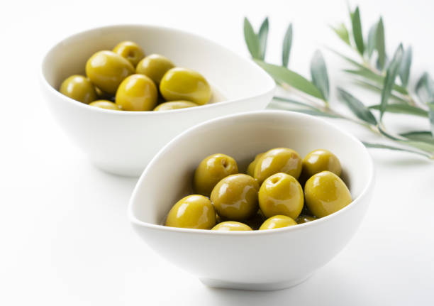 istock Salted olives and olive branches placed on a white background 1286269413