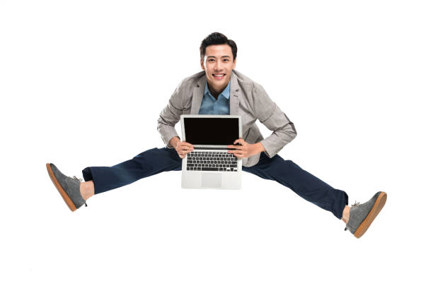 istock Carrying a laptop bouncing youth business man 1286271416