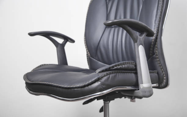 istock Black leather office chair in grey background. 1286272228